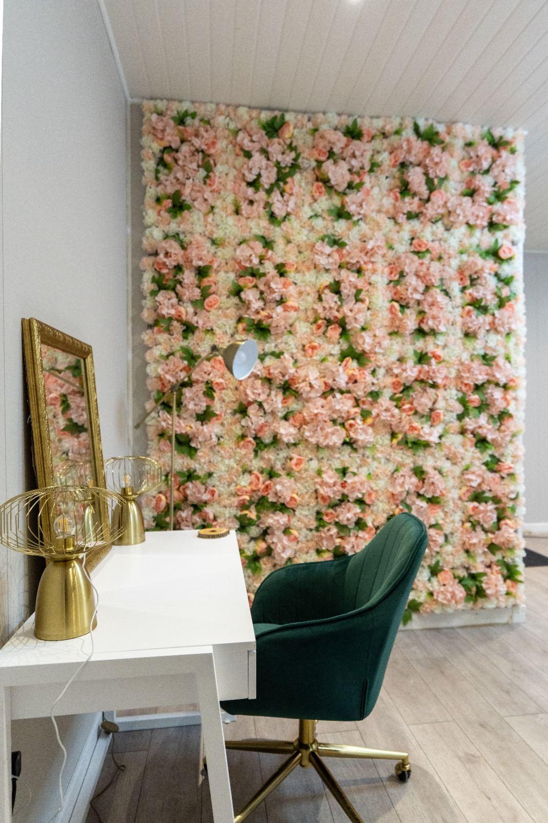 Pink flower wall photo booth setup